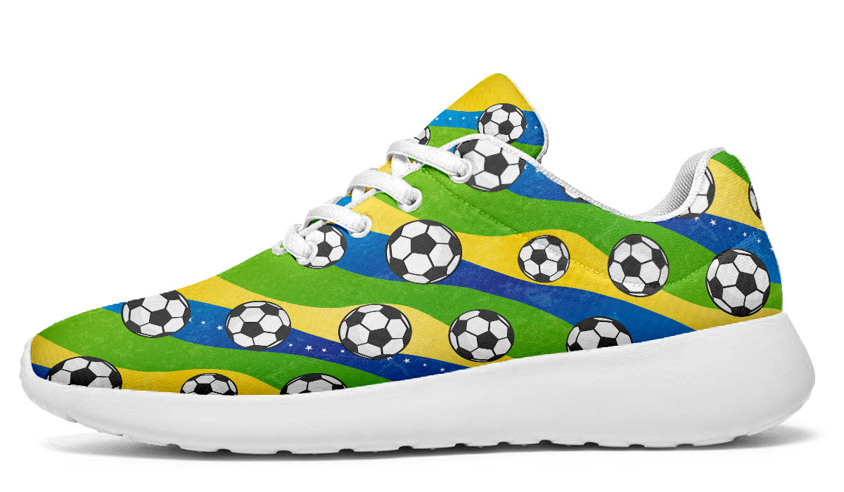 Brazil-inspired sport shoes featuring soccer ball patterns with green, yellow, and blue flag-inspired artwork.
