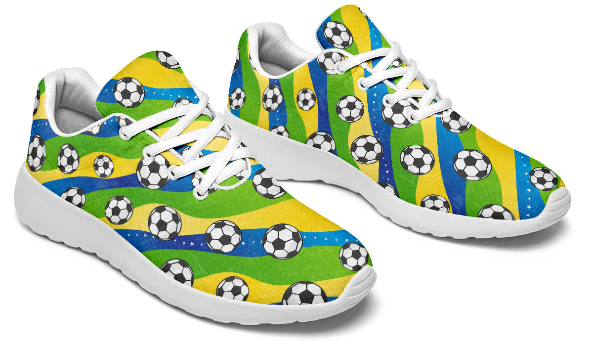 Brazil-inspired sport shoes featuring soccer ball patterns with green, yellow, and blue flag-inspired artwork.