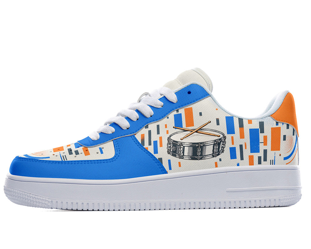 Court sneaker in white sole with a side view featuring a silver snare drum with drumsticks over blue and orange equalizer block patterns.