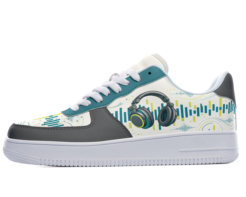 A low-top sneaker featuring a white and gray base with teal and lime green graphic patterns, including a headphone illustration and soundwave design, on a clean white background.