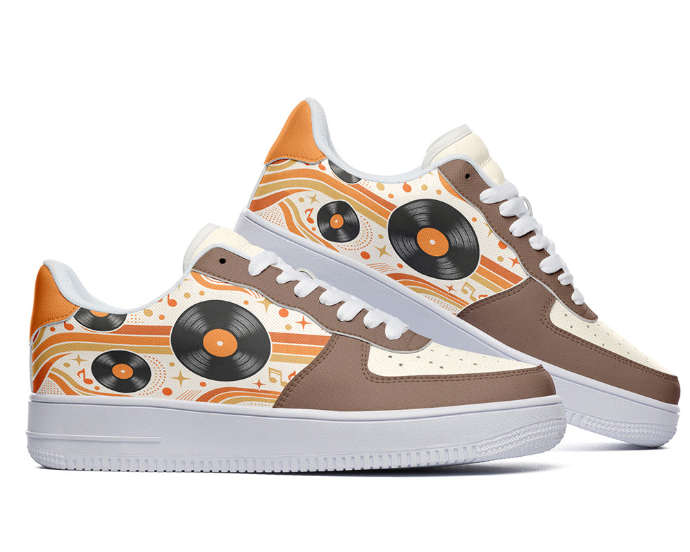Court sneakers in white sole featuring black vinyl LP records over orange and cream retro wave lines with brown leather overlays.