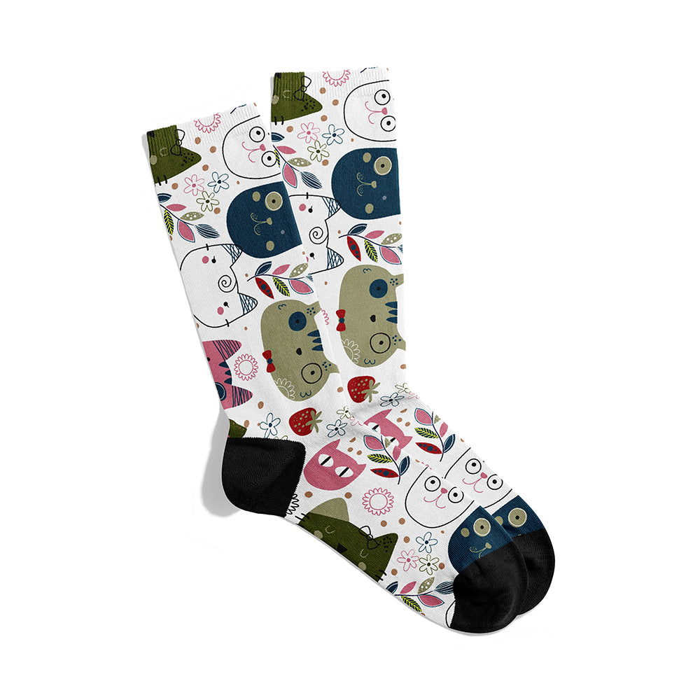A pair of white kitty socks with a multicolored pattern, featuring cartoon cats and other playful designs.